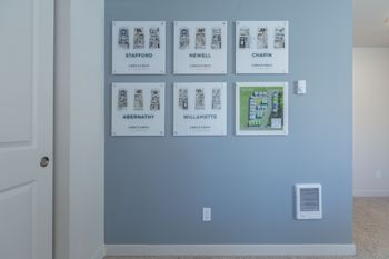 Floor plan display wall showing multiple unit layouts